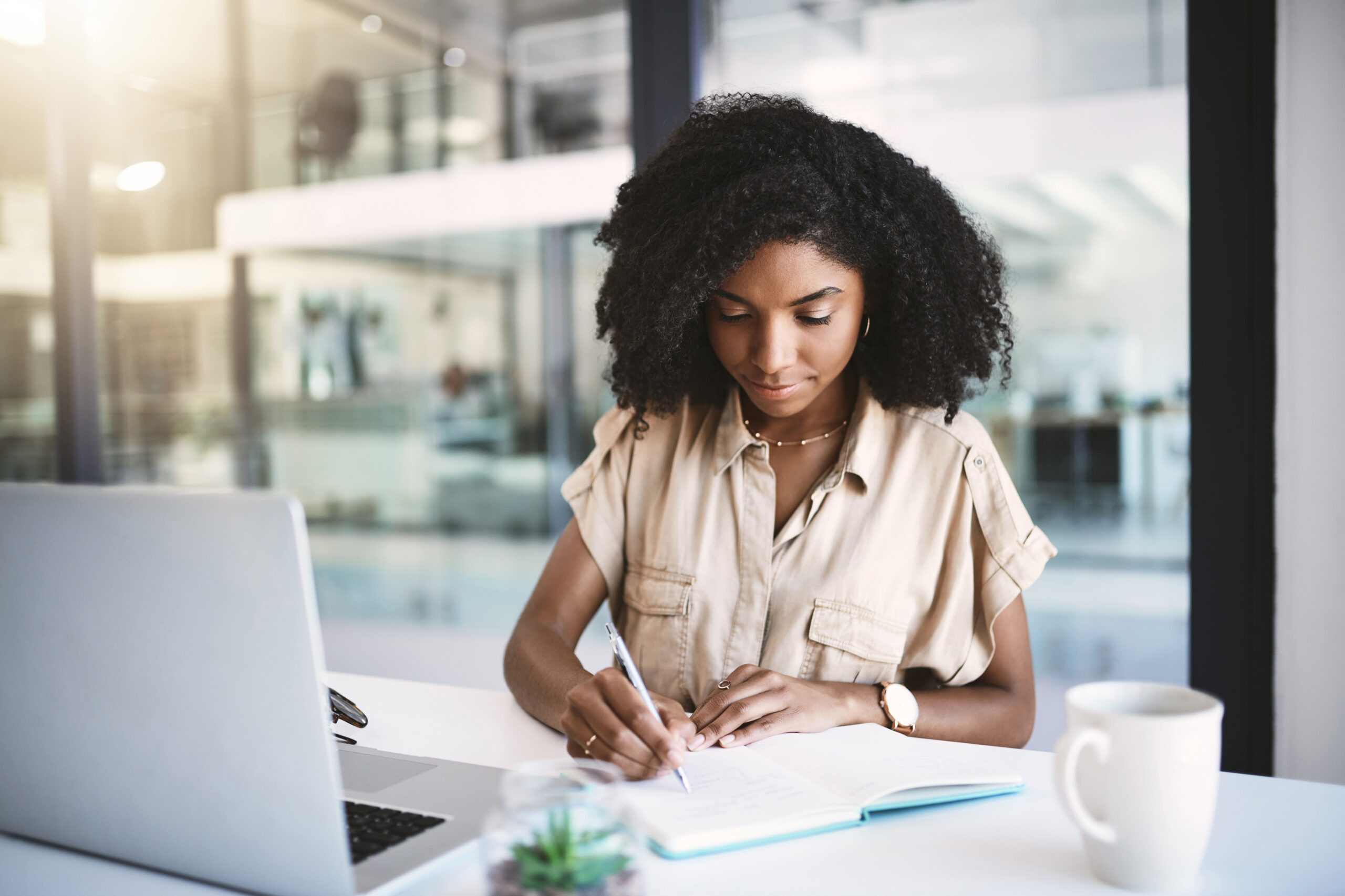 Office, black woman and writer with notebook for writing, notes and information for news article with pen. Workplace, journal and female journalist for planning, reading and research for story.