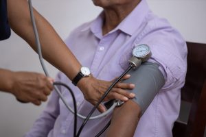 A Mexican nurse measuring the pulse of the patient